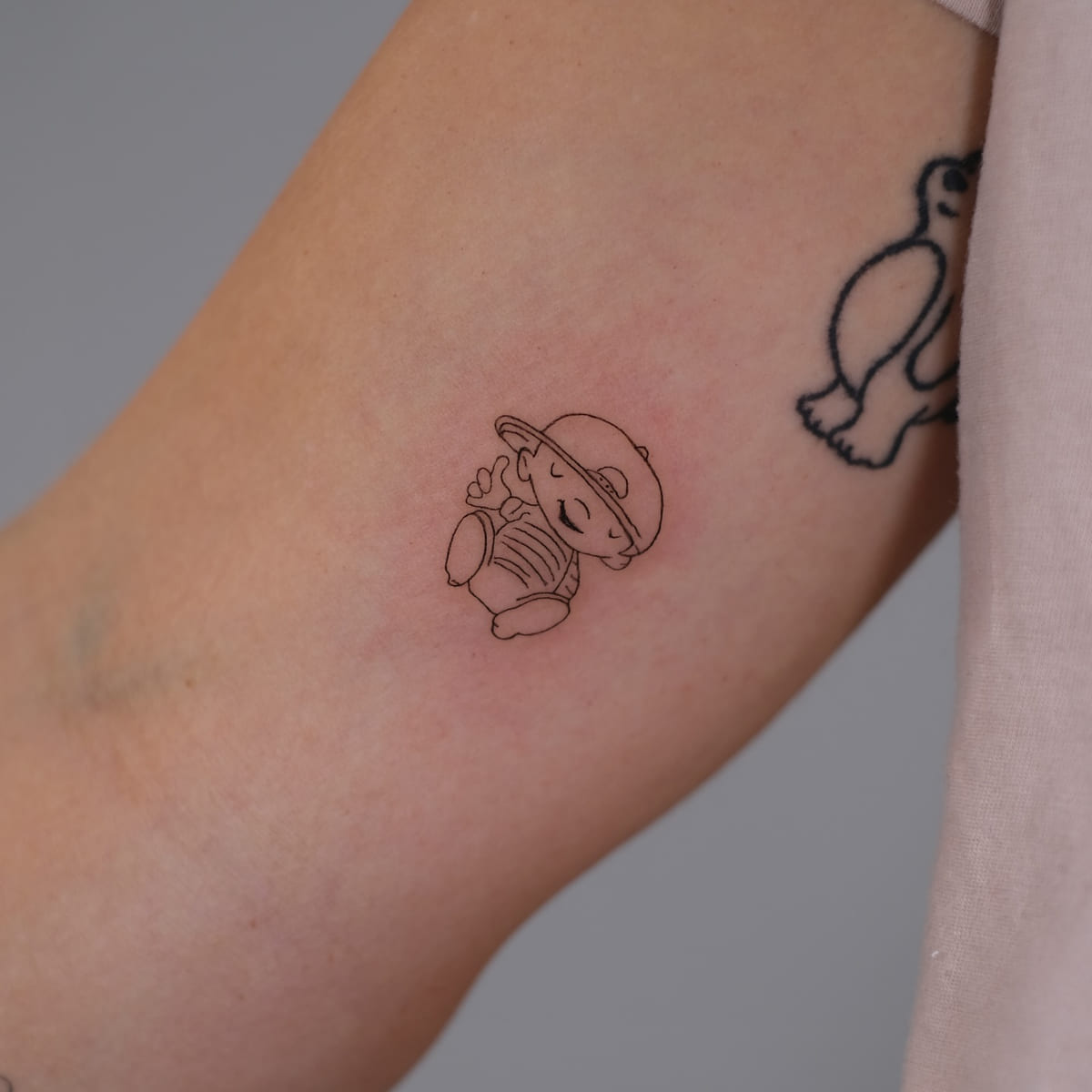 Small sitting character in a cap, another view