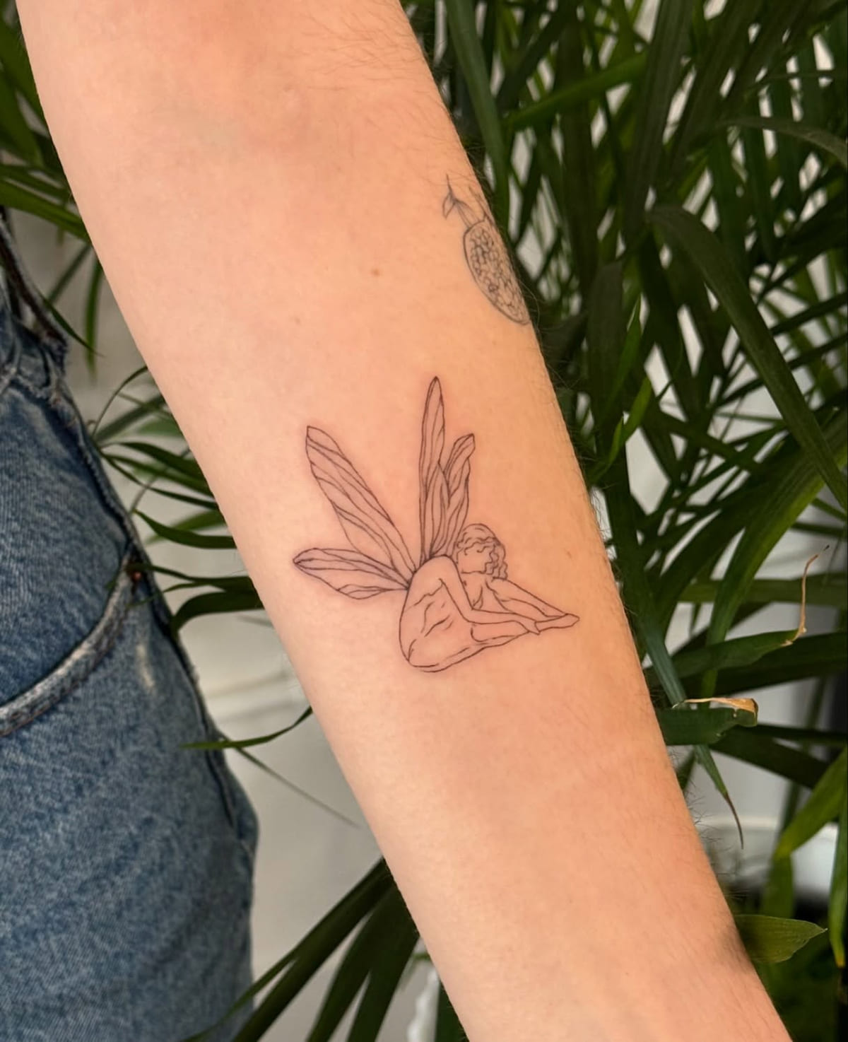 Seated fairy with tall wings, fine line tattoo