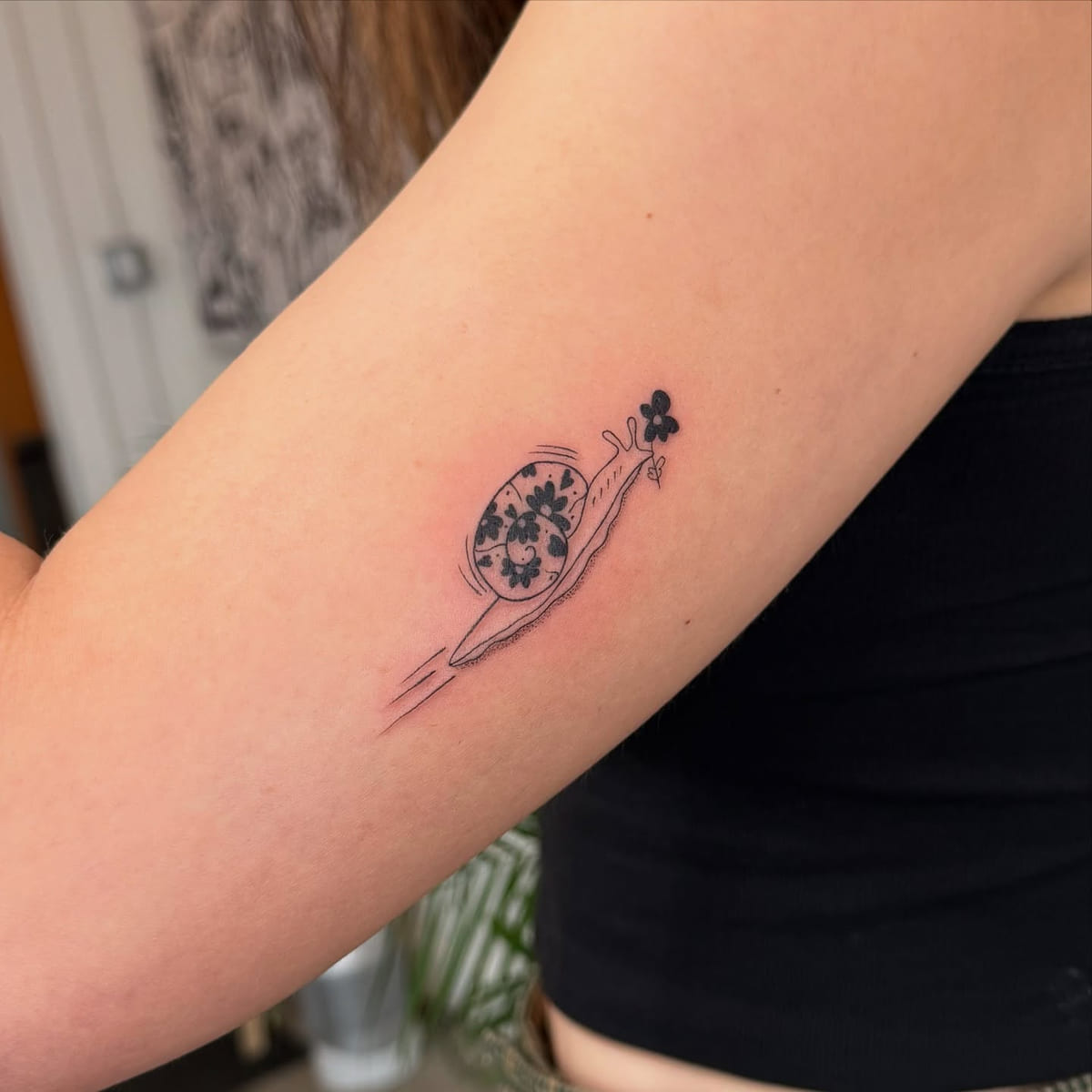 Snail with a flower patterned shell, fine line tattoo