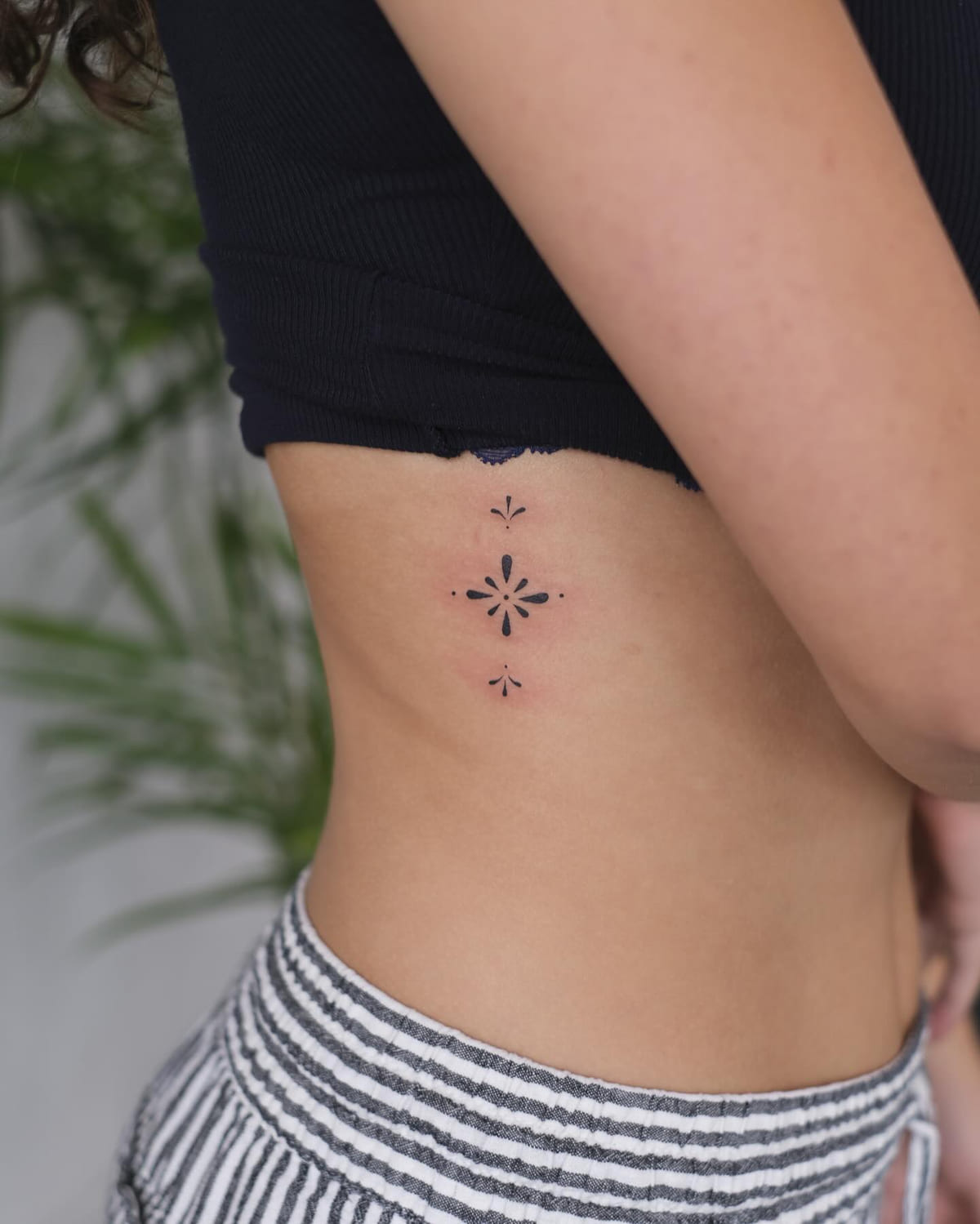 Small vertical ornament of three marks, fine line tattoo