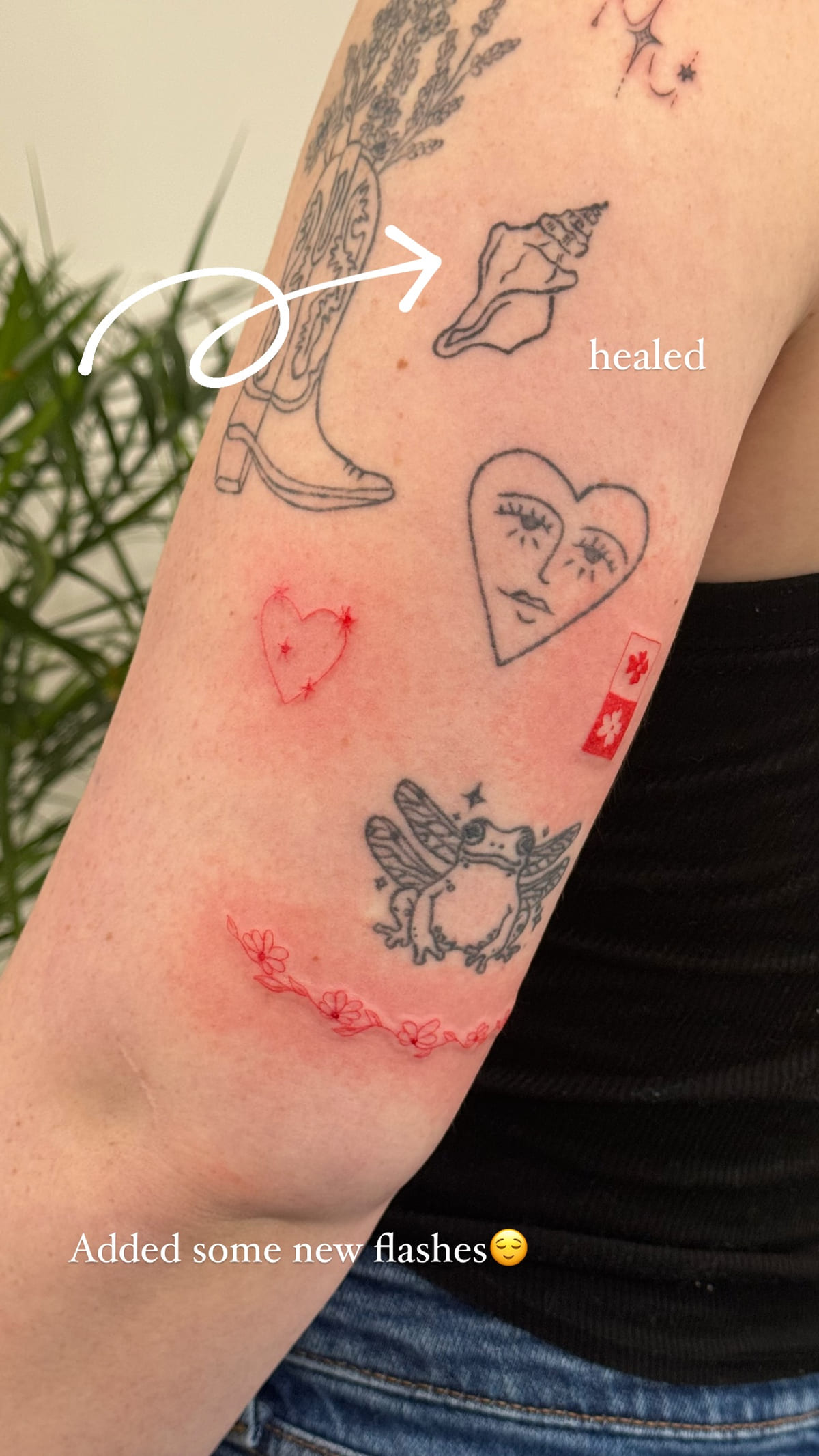 Red Valentine flash among healed pieces, healed fine line tattoo