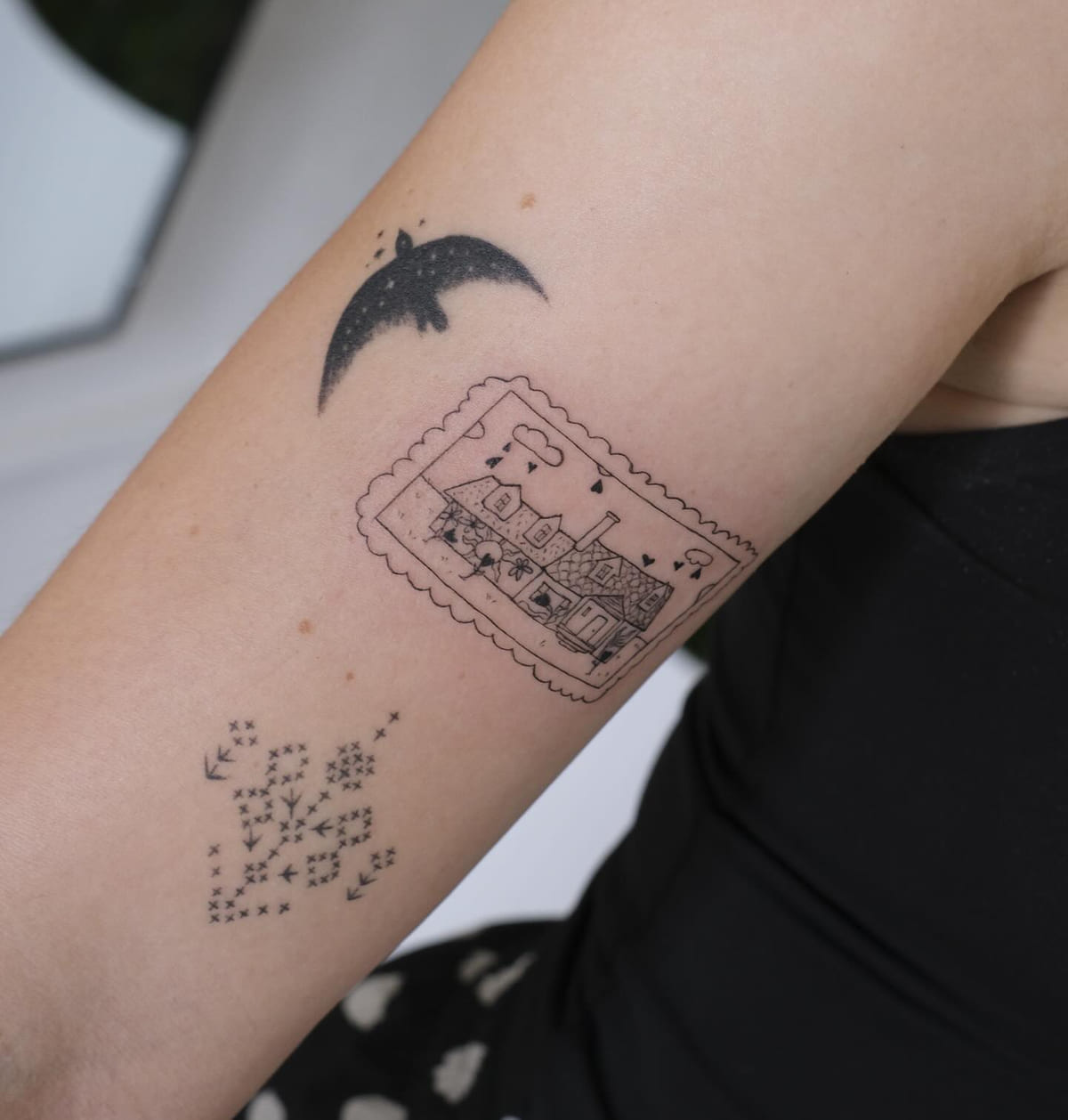 Postage stamp of a train with music notes, and a starry crescent moon, fine line tattoo