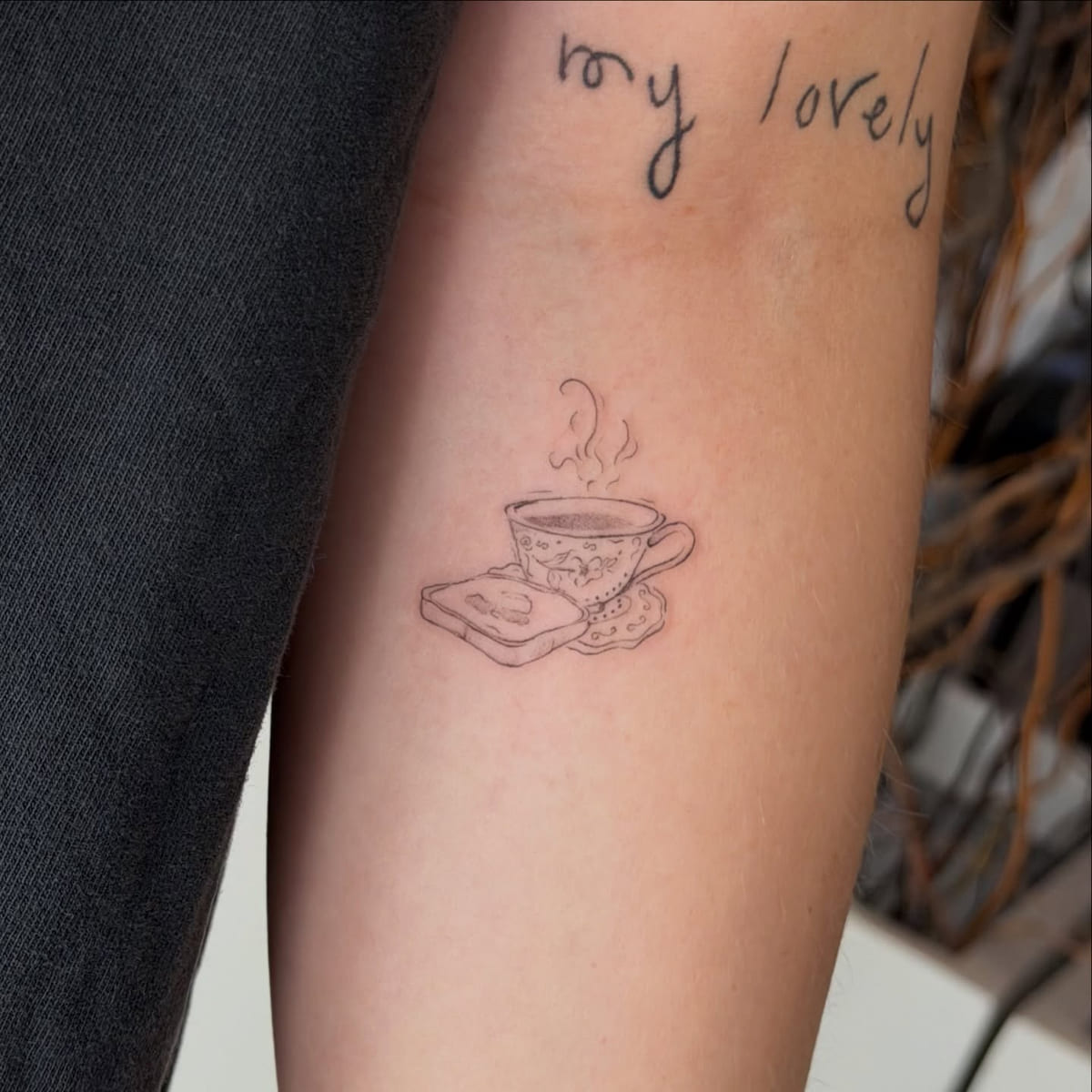Steaming teacup on a book, another view
