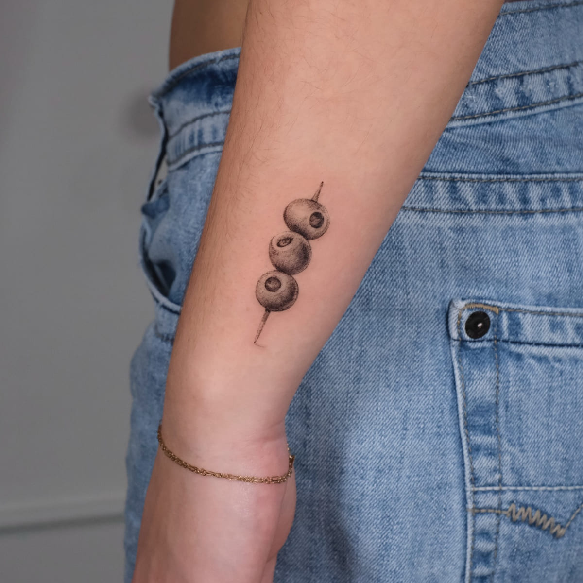 Three olives on a pick, micro realism, fine line tattoo