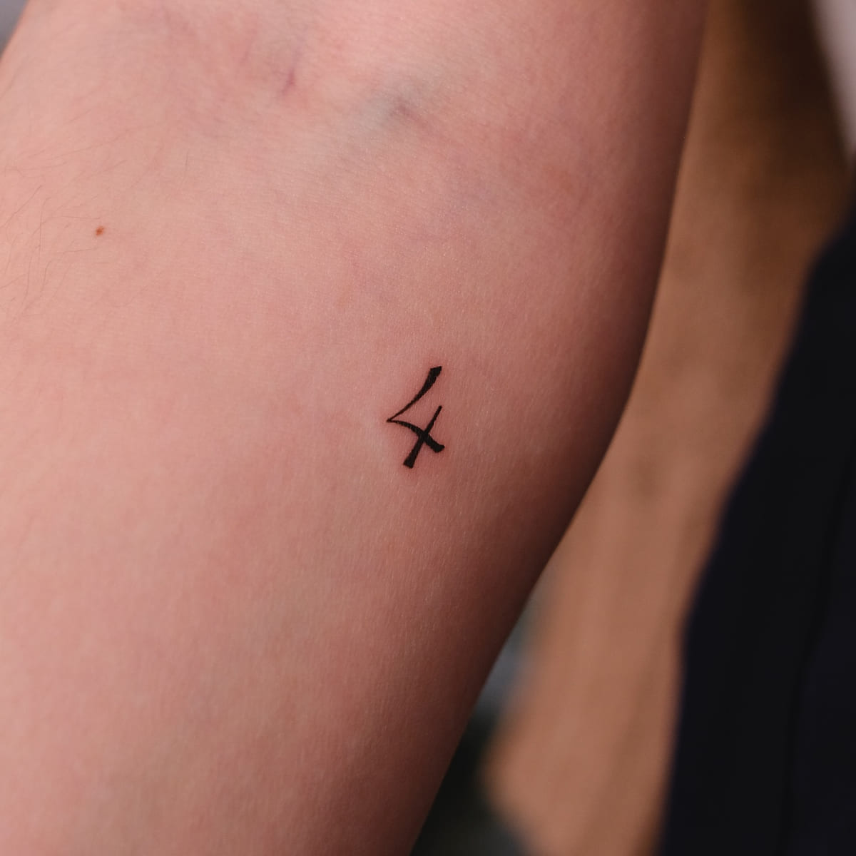 Tiny solid glyph, fine line tattoo