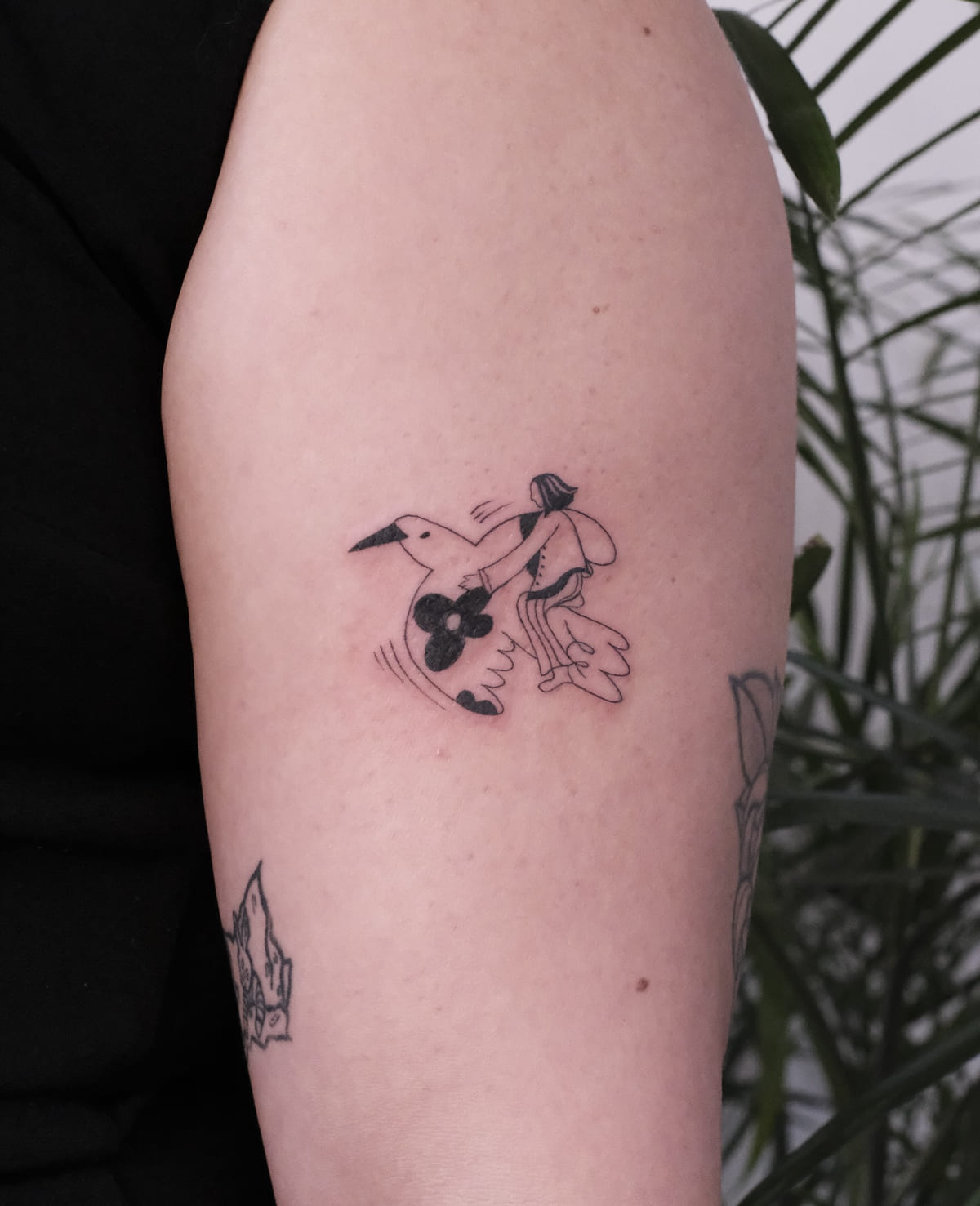Stork carrying a small figure, solid black accents, fine line tattoo
