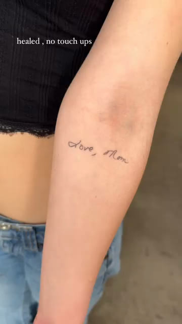 Handwriting on an inner forearm, healed fine line tattoo
