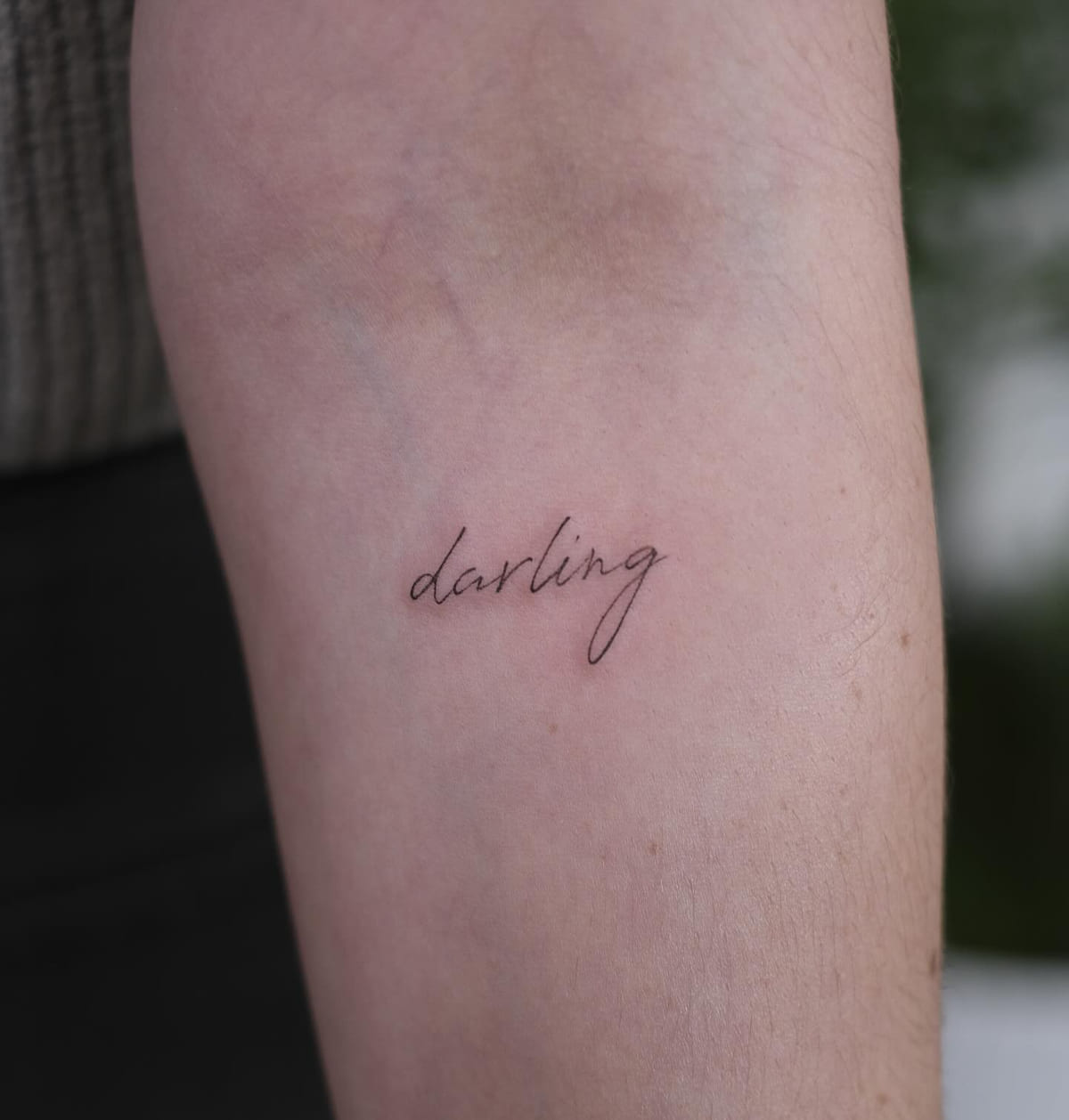 Handwritten word: darling, fine line tattoo