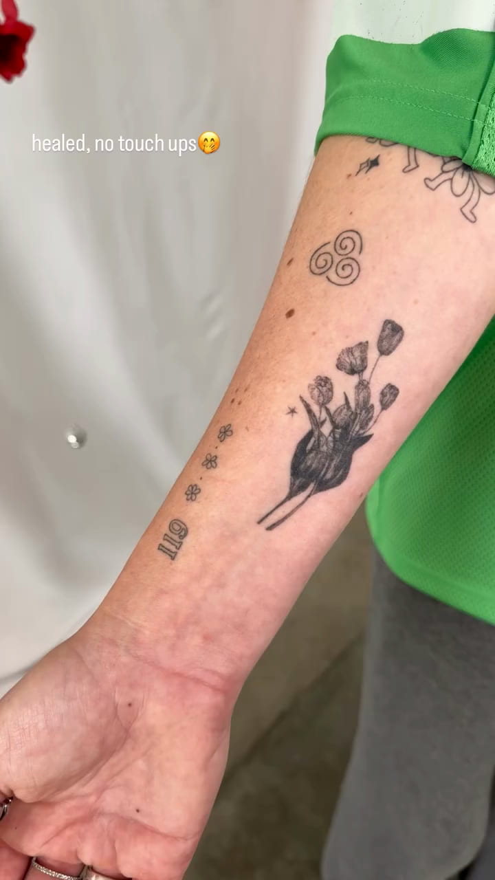 Solid black tulips on a forearm, healed fine line tattoo, healed