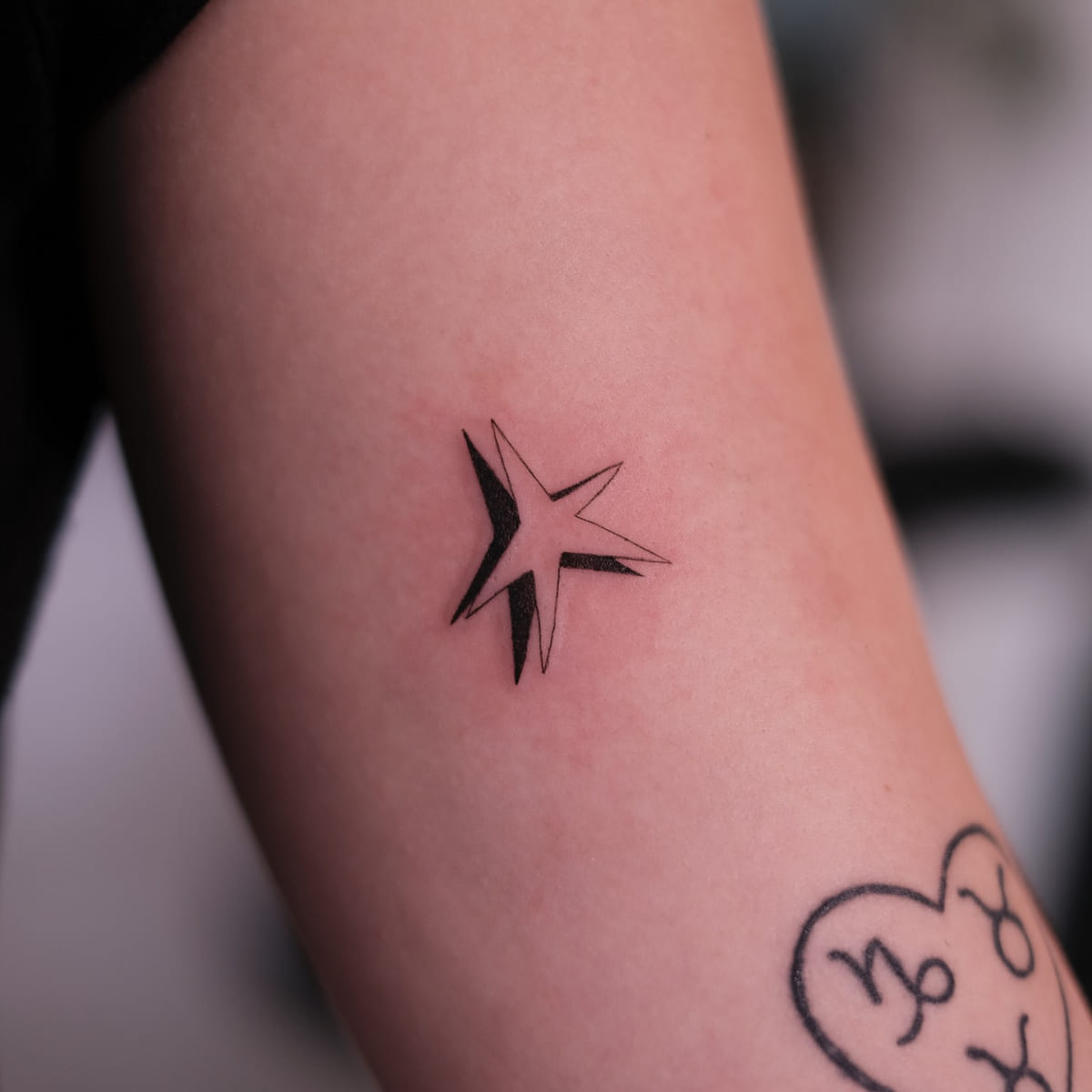 Five point star with a solid shadow, fine line tattoo