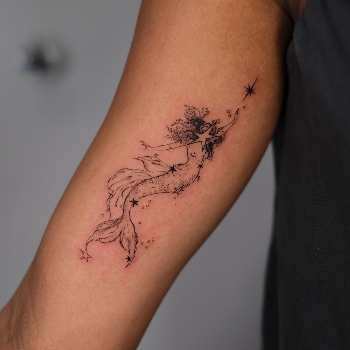 Mermaid reaching for a star, fine line tattoo