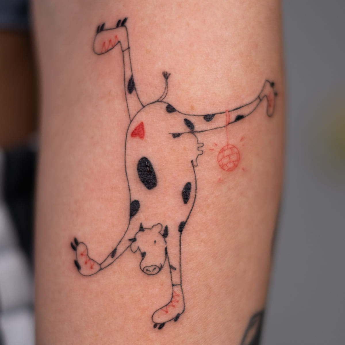 Handstand cow, fine line tattoo