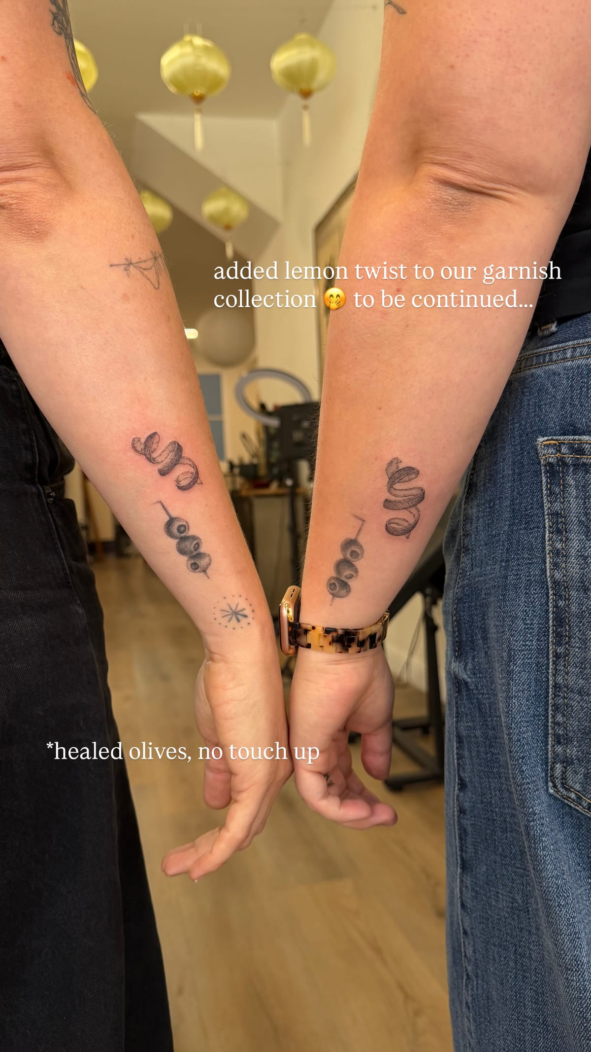 Matching olives on two forearms, healed fine line tattoo