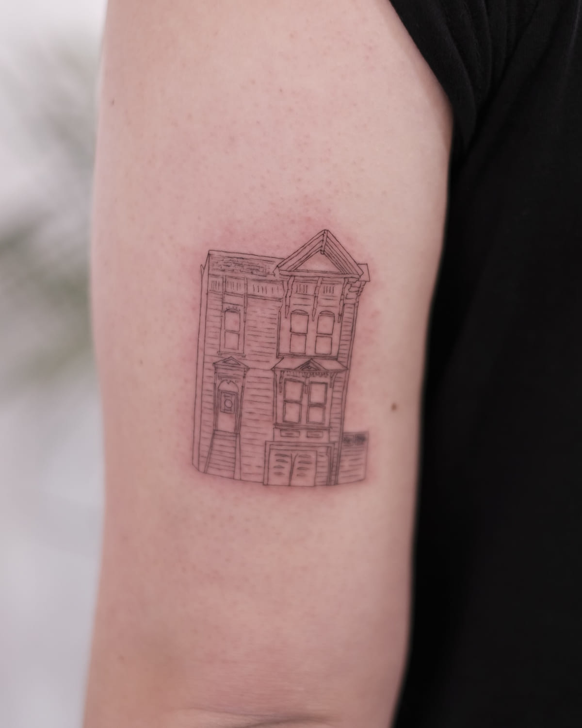 Victorian house facade on a forearm, healed fine line tattoo, the day it was made
