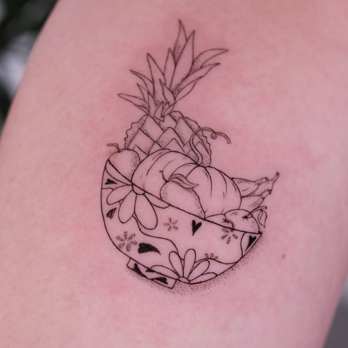 Patterned bowl of fruit with a pineapple, another view