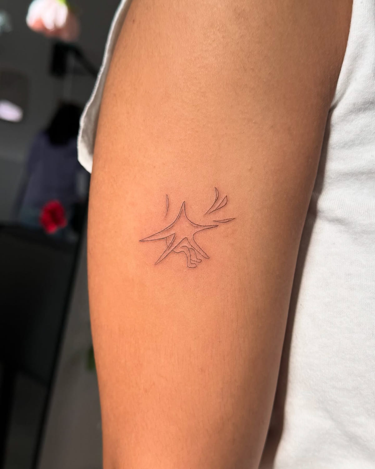 Star character with little arms, fine line tattoo