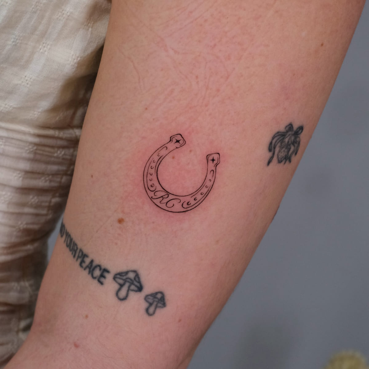 Horseshoe, fine line tattoo