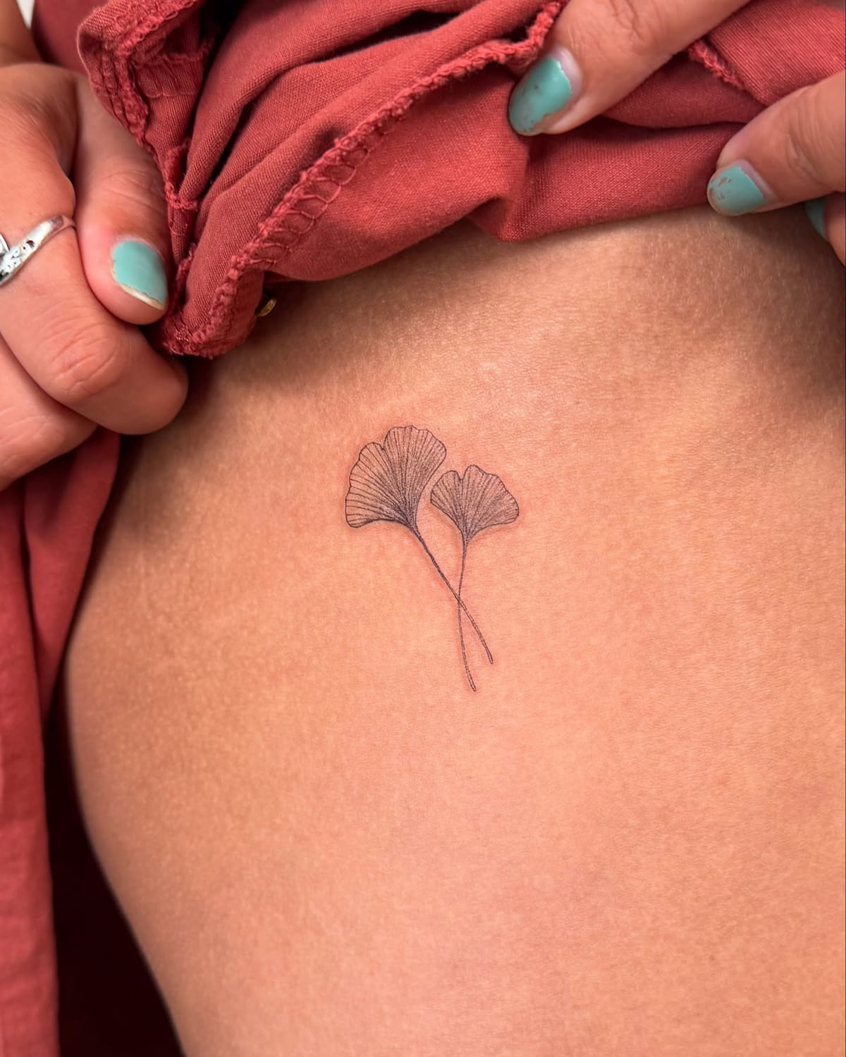 Two ginkgo leaves, fine line tattoo