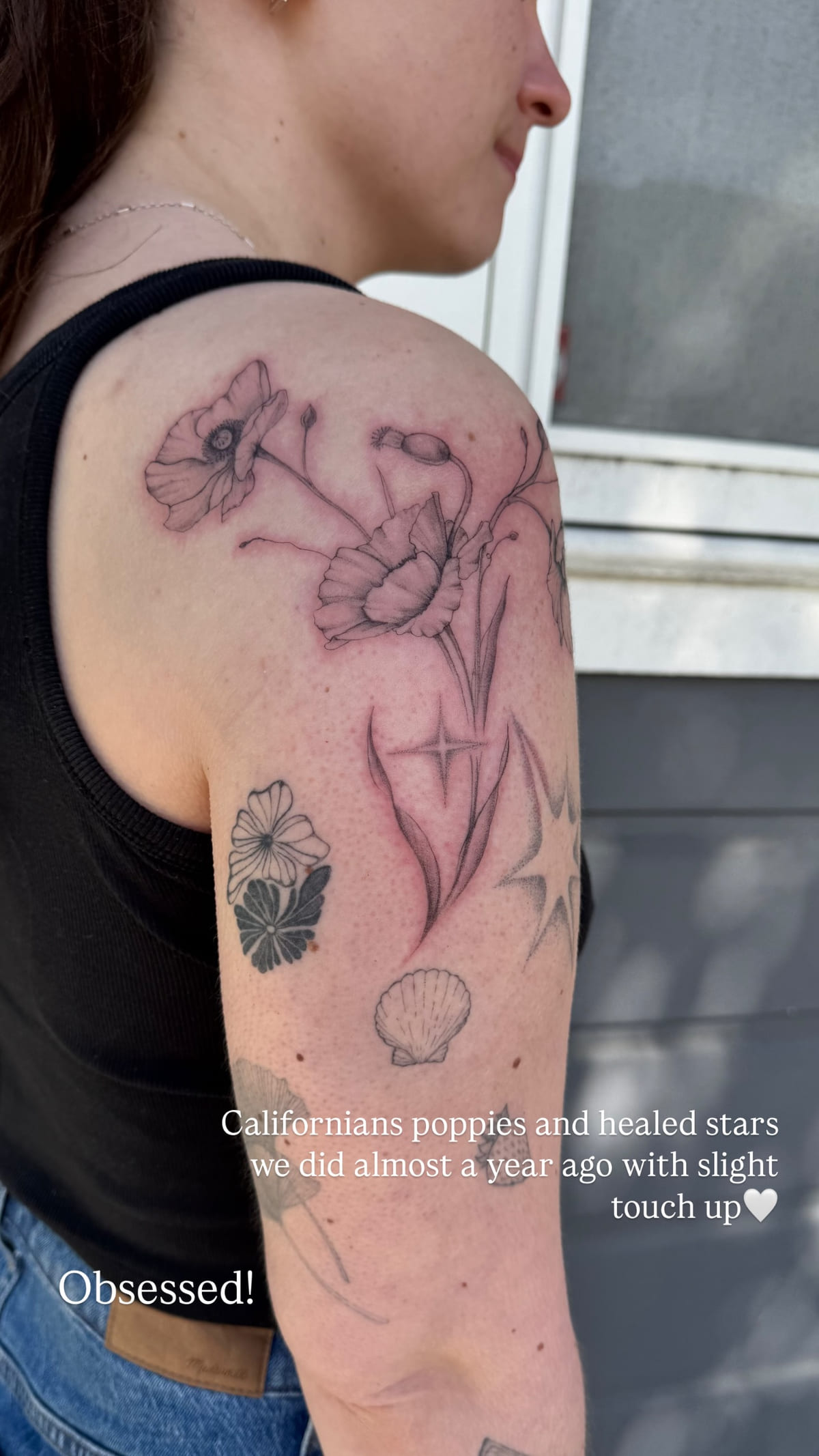 Sparkle stars on a shoulder, beside new California poppies, healed fine line tattoo