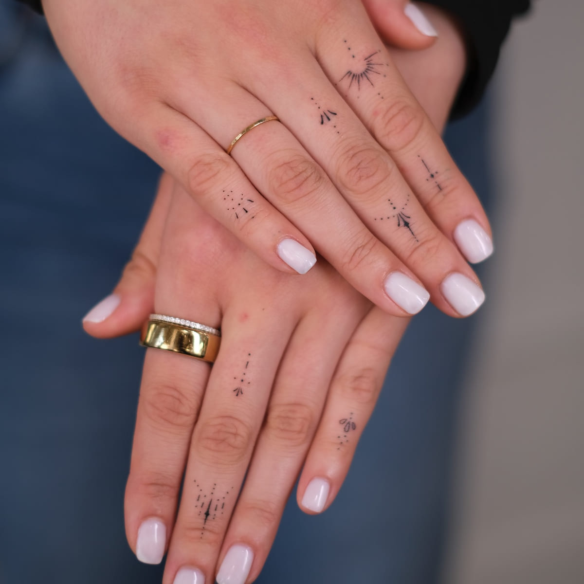 Tiny ornaments on the fingers of both hands, fine line tattoo