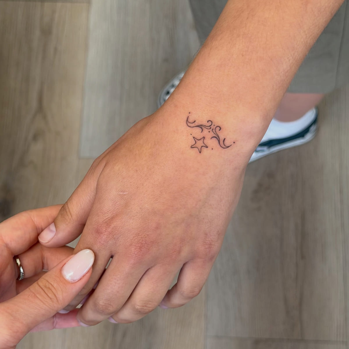 Swirl ornament with a star, fine line tattoo