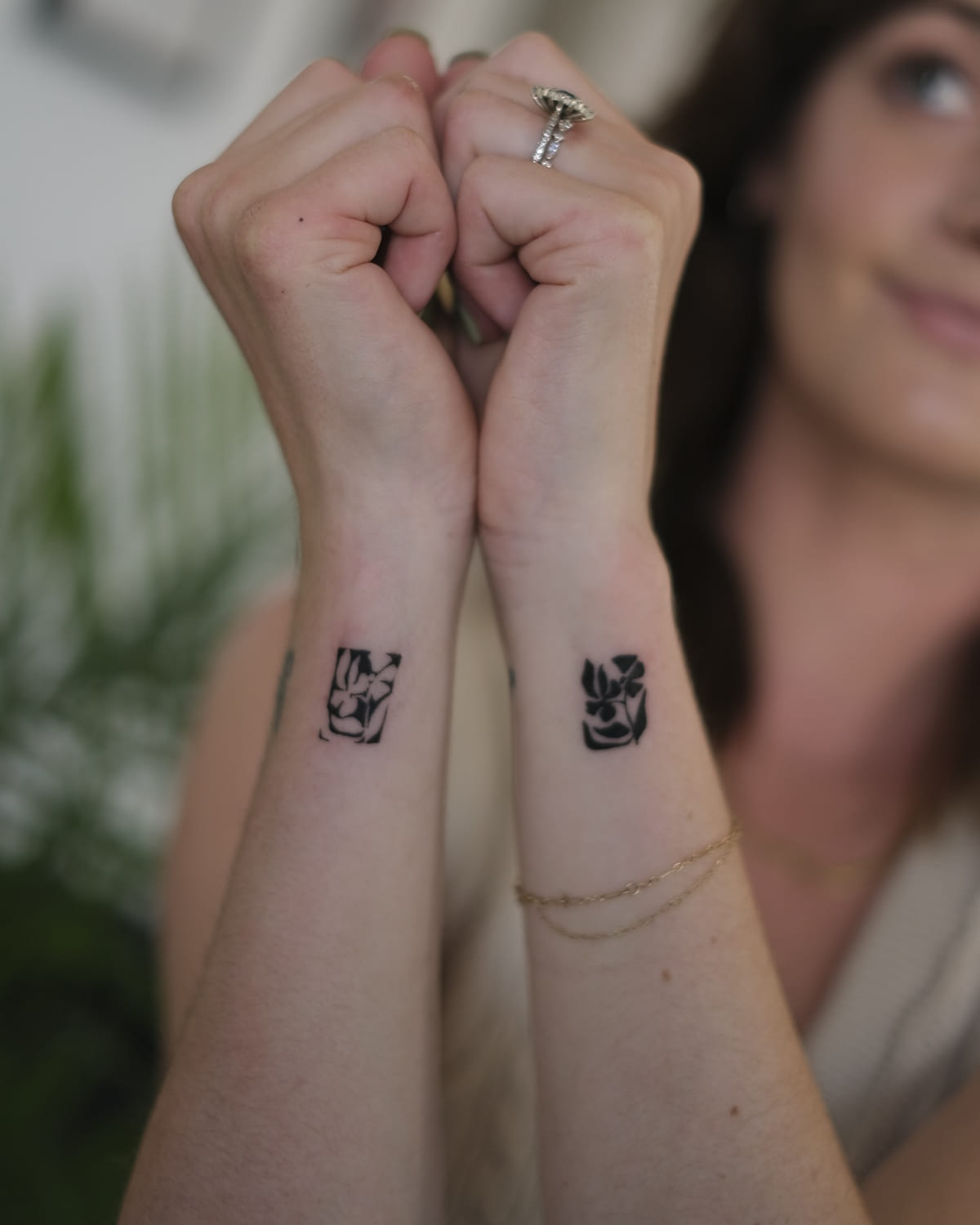 Two solid black flower blocks, one on each wrist, another view