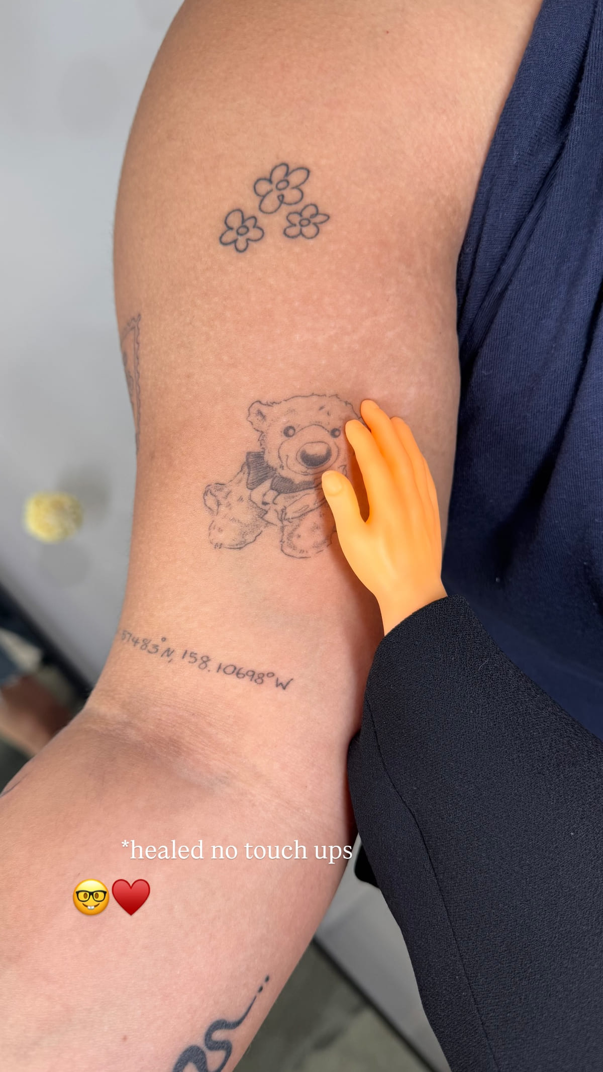 Small teddy bear on a forearm, healed fine line tattoo