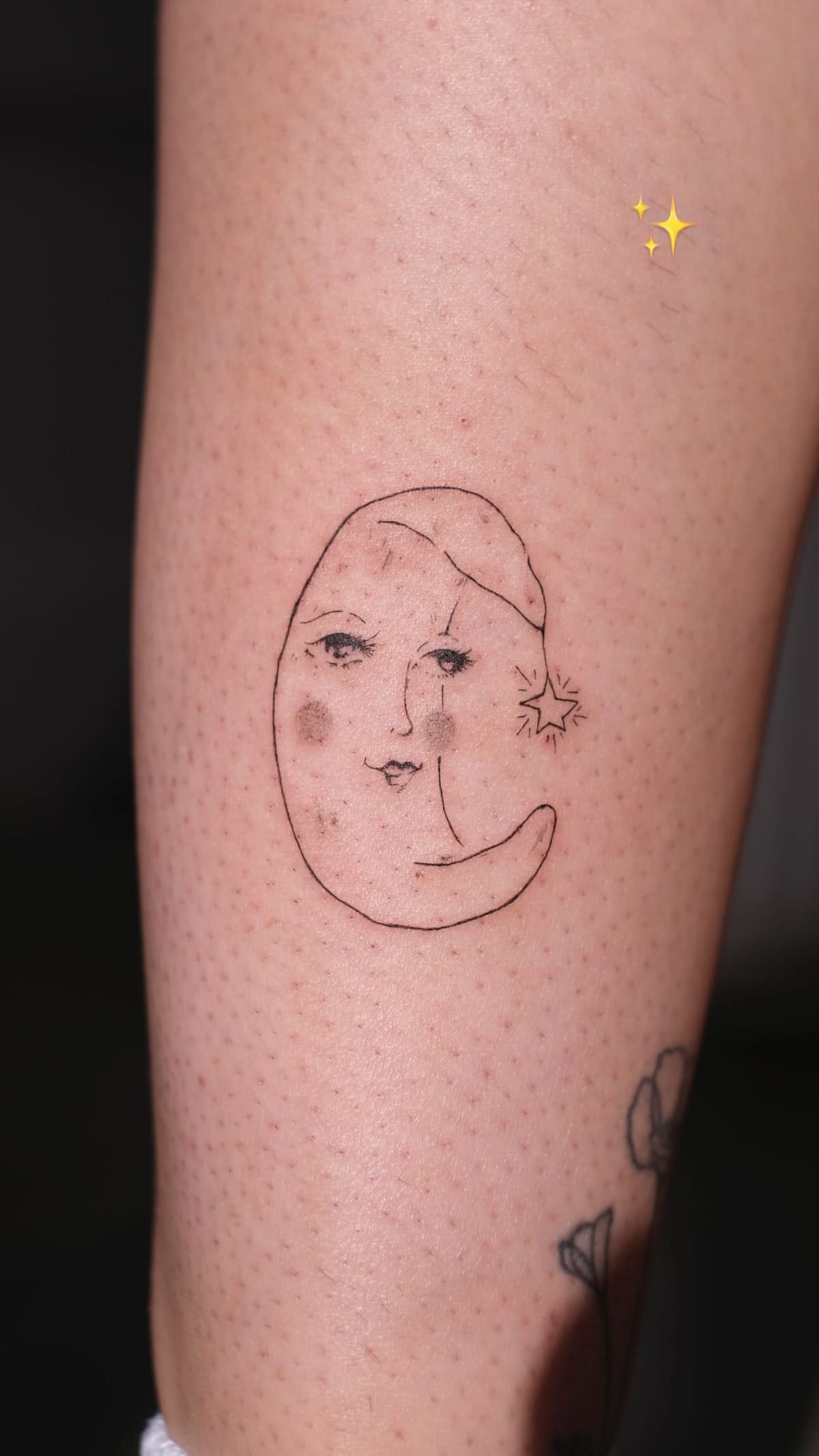 Moon with a face and a nightcap on a calf, healed fine line tattoo, the day it was made