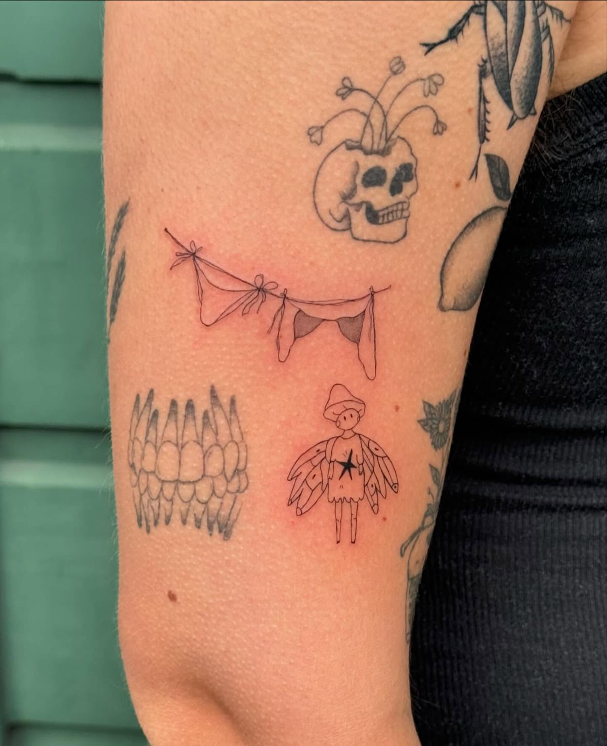Bunting with bows and a small winged figure with a star, fine line tattoo