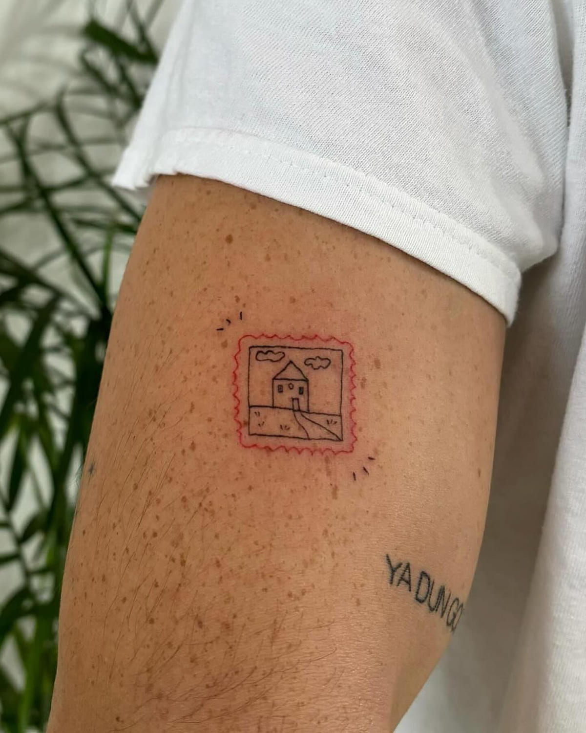 Postage stamp with a house, red scalloped border, fine line tattoo