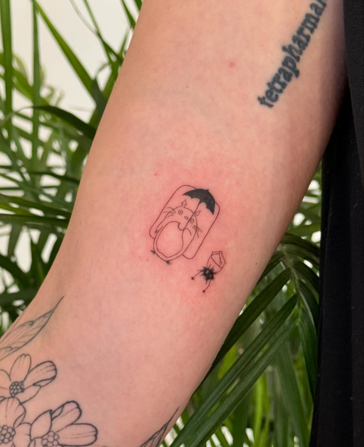 Totoro under an umbrella in a jar outline, with a soot sprite, fine line tattoo