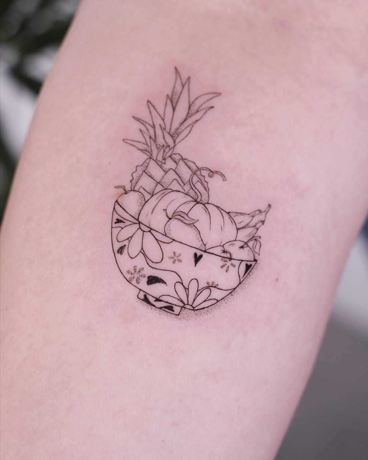 Patterned bowl of fruit with a pineapple, fine line tattoo