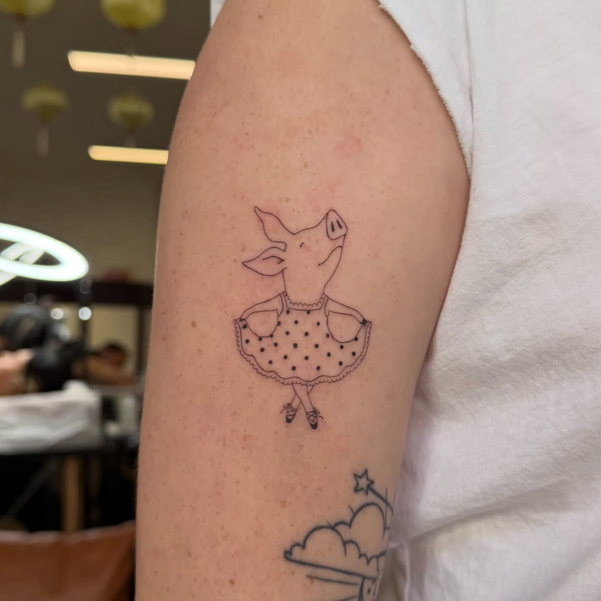 Pig in a polka dot dress, fine line tattoo