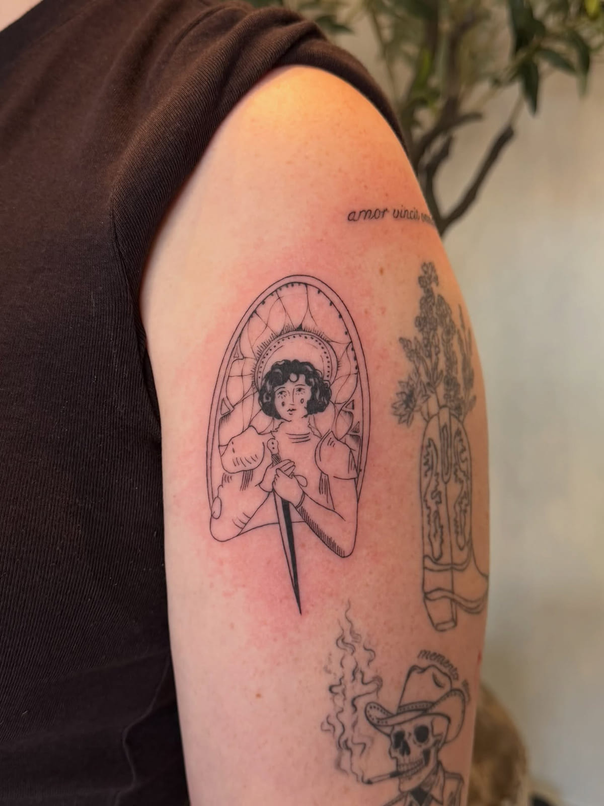 Woman with a dagger in an arched frame, healed fine line tattoo, the day it was made