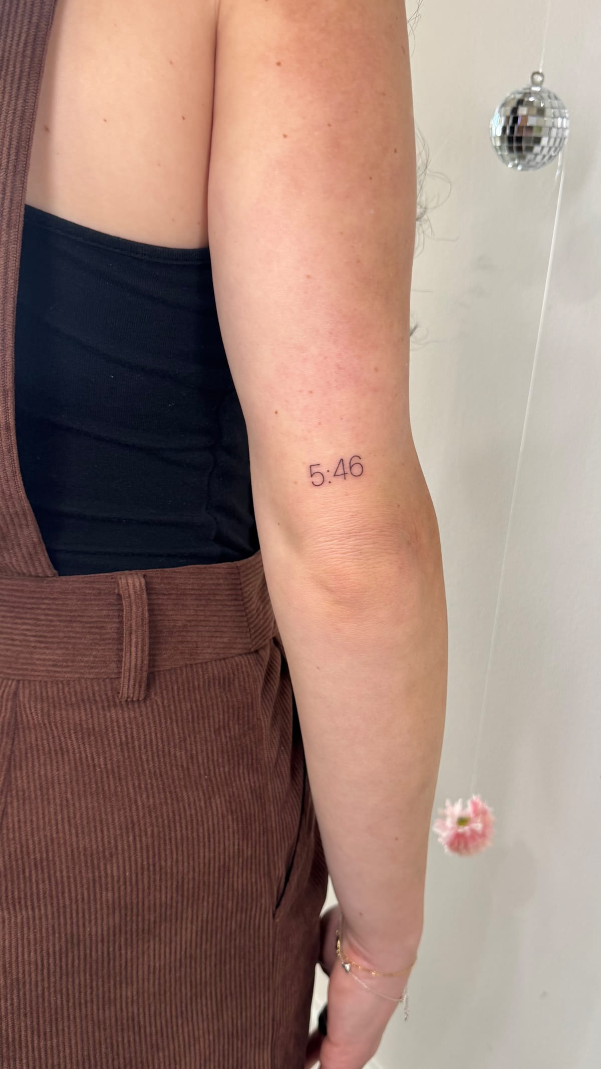 Red bow and the numerals 5:46, healed fine line tattoo, the day it was made