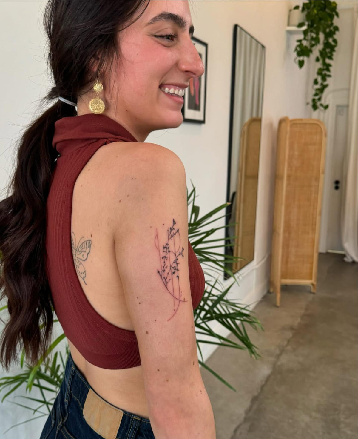 Lavender sprig on an upper arm, fine line tattoo