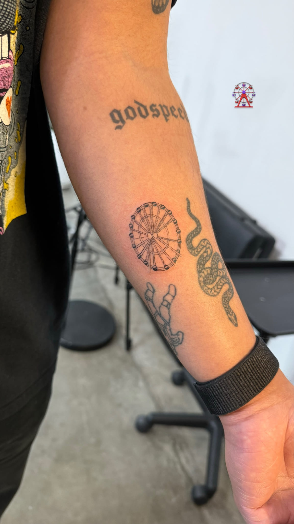 Small Ferris wheel on a forearm, fine line tattoo