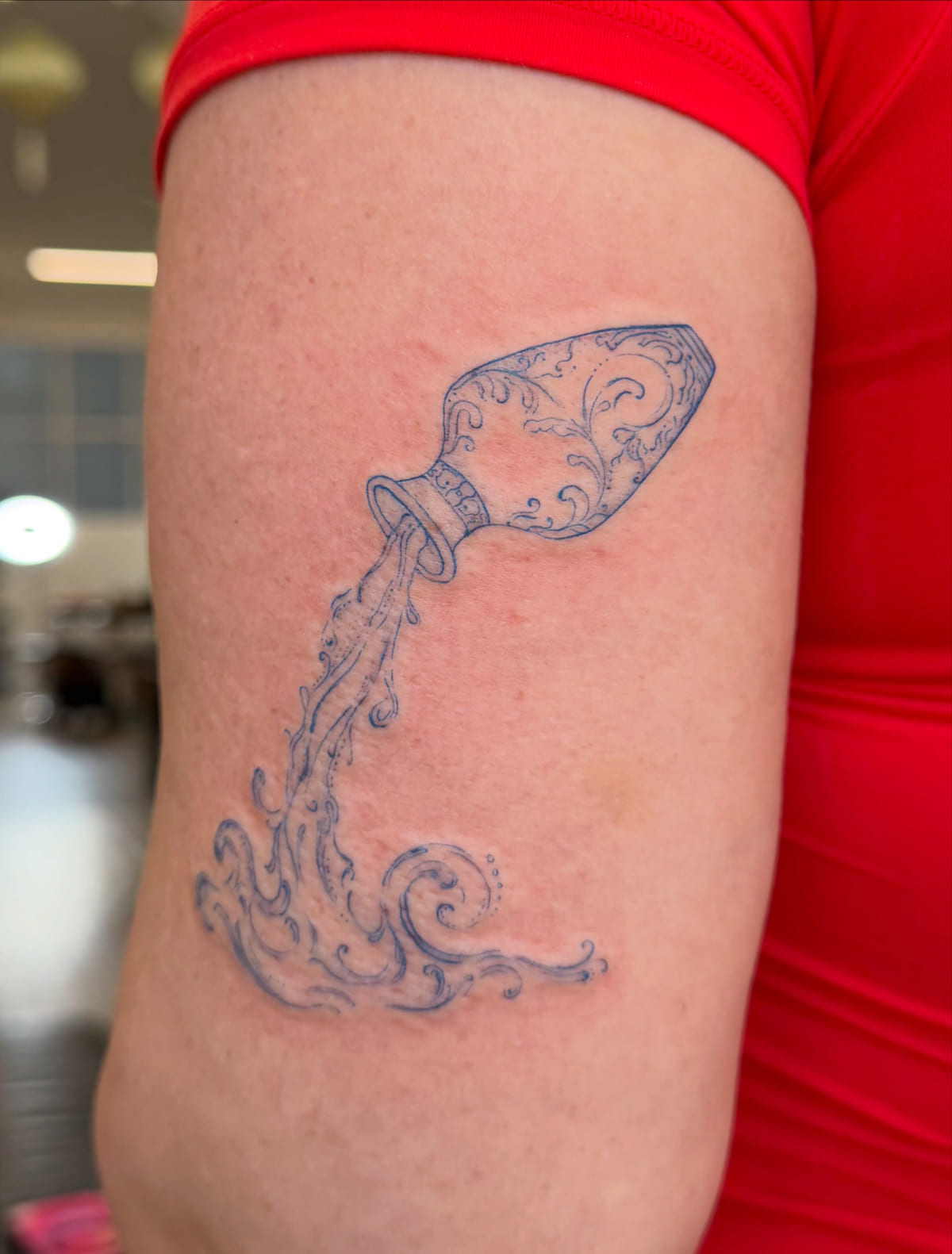 Porcelain vase pouring water, all in blue, fine line tattoo