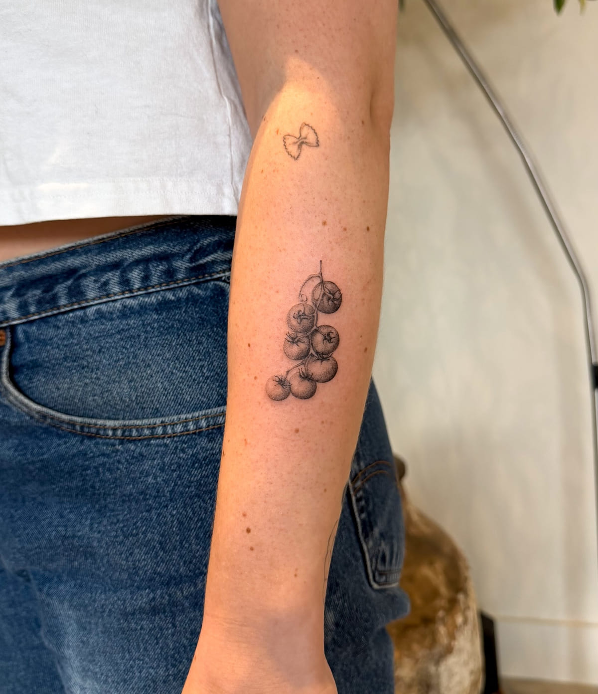 Cherry tomatoes on the vine, micro realism, fine line tattoo