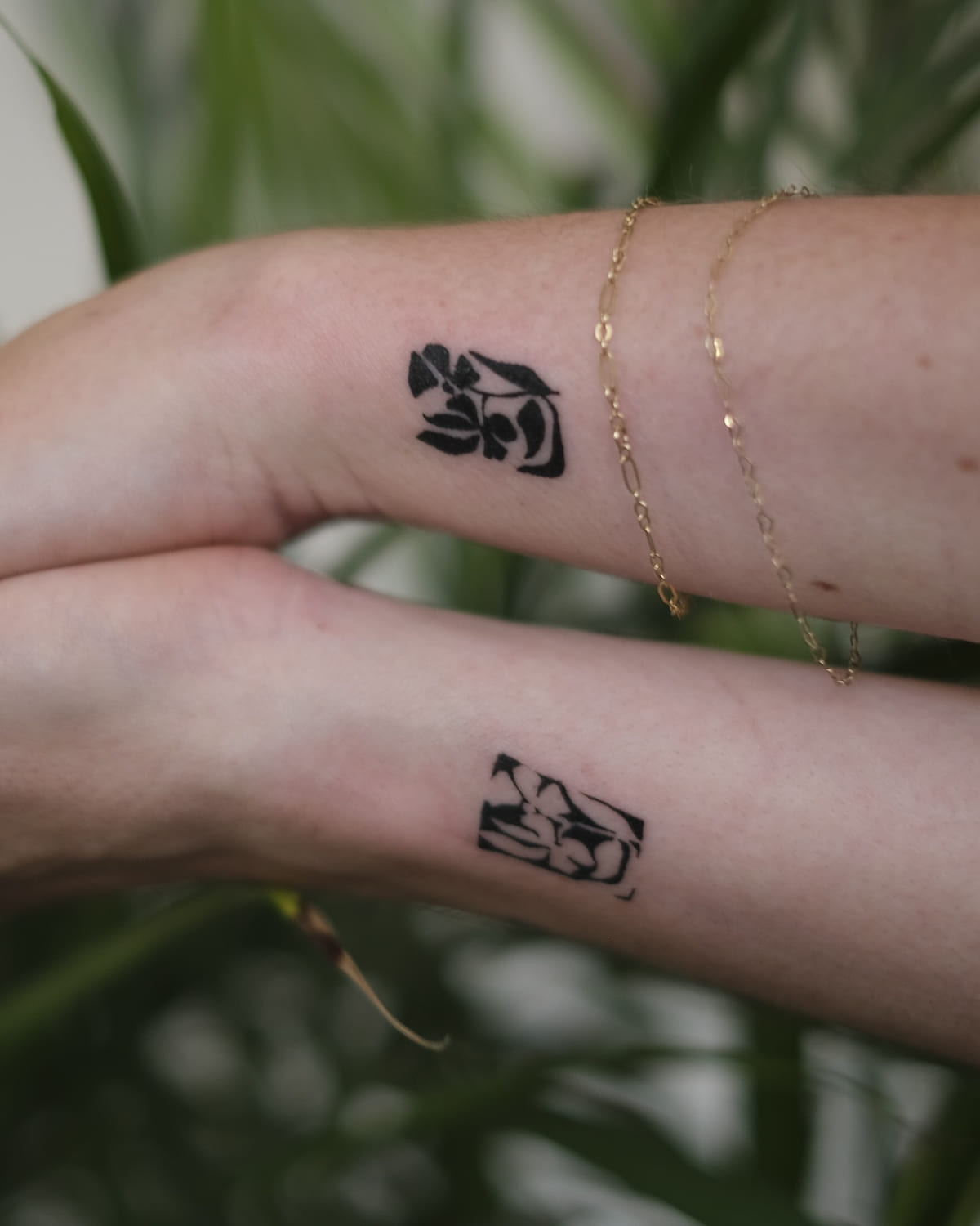 Two solid black flower blocks, one on each wrist, another view