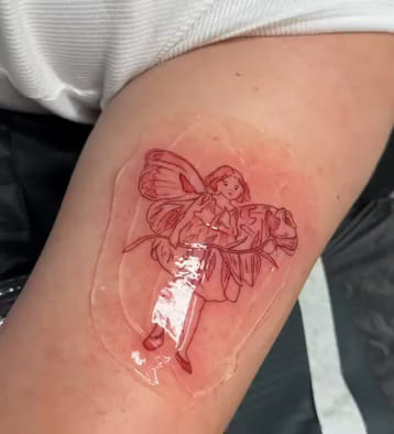 Flower fairy with forget me nots, after the classic illustration, fine line tattoo