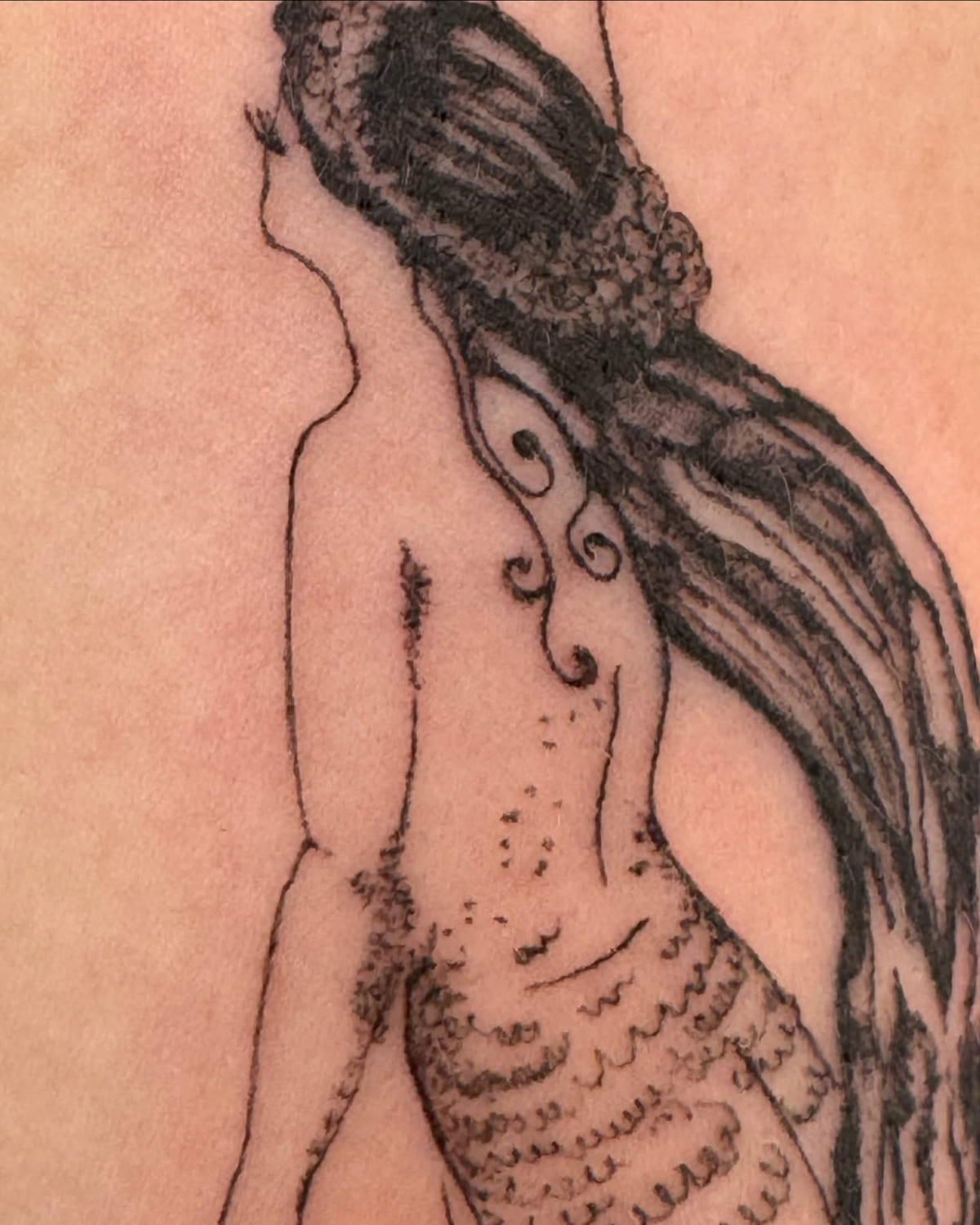 Mermaid seen from behind, reaching up, long hair and long tail, another view