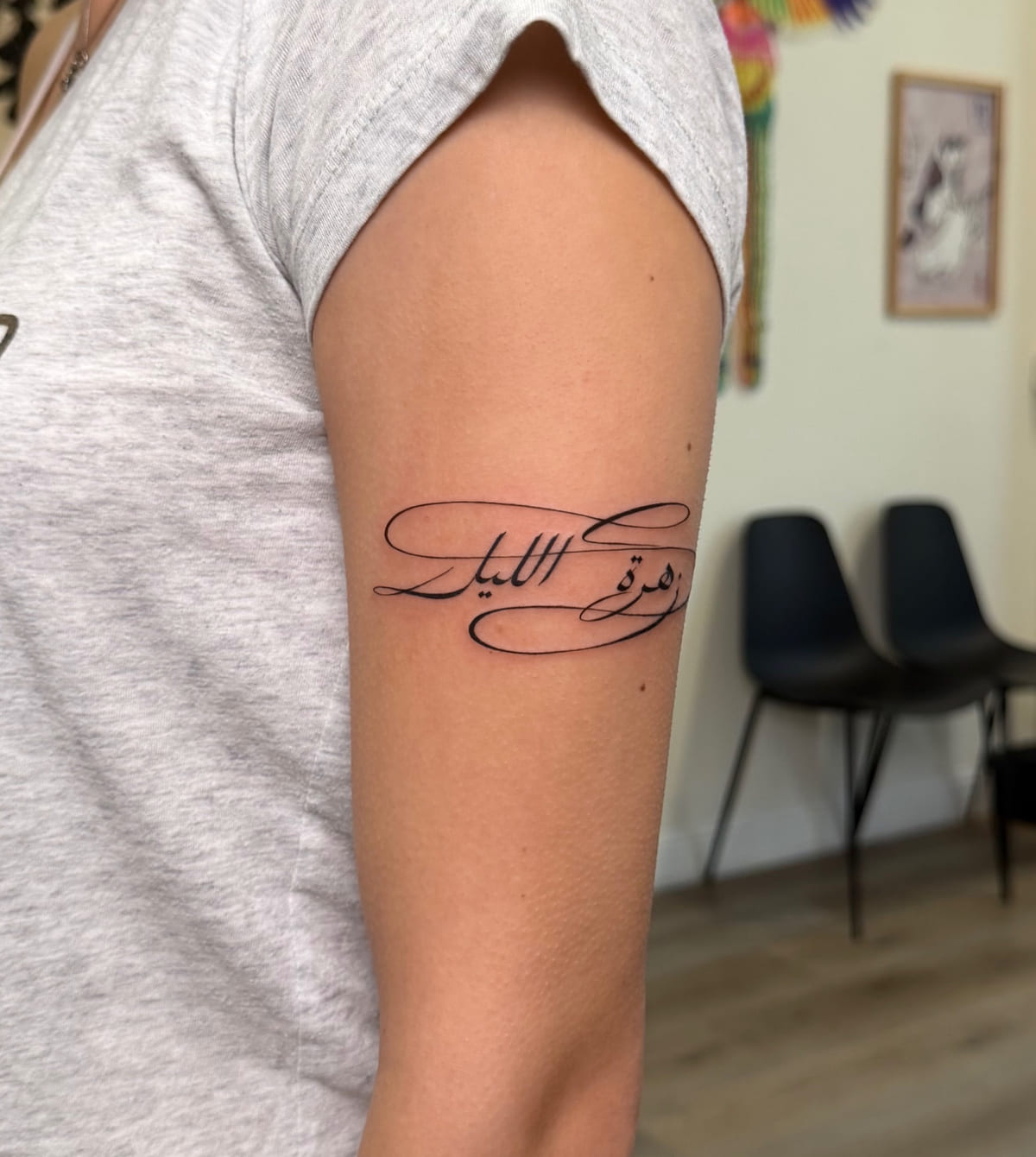 Arabic calligraphy, flowing script, fine line tattoo