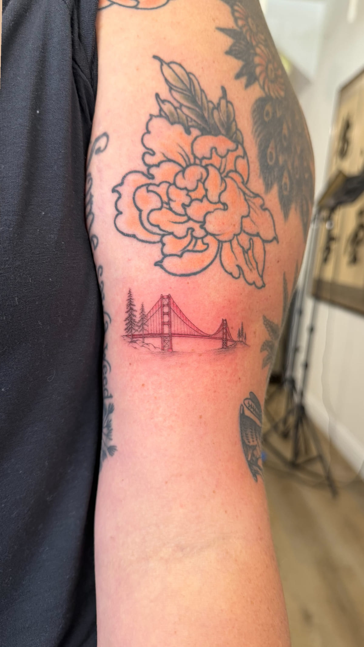 Red Golden Gate Bridge with trees, fine line tattoo