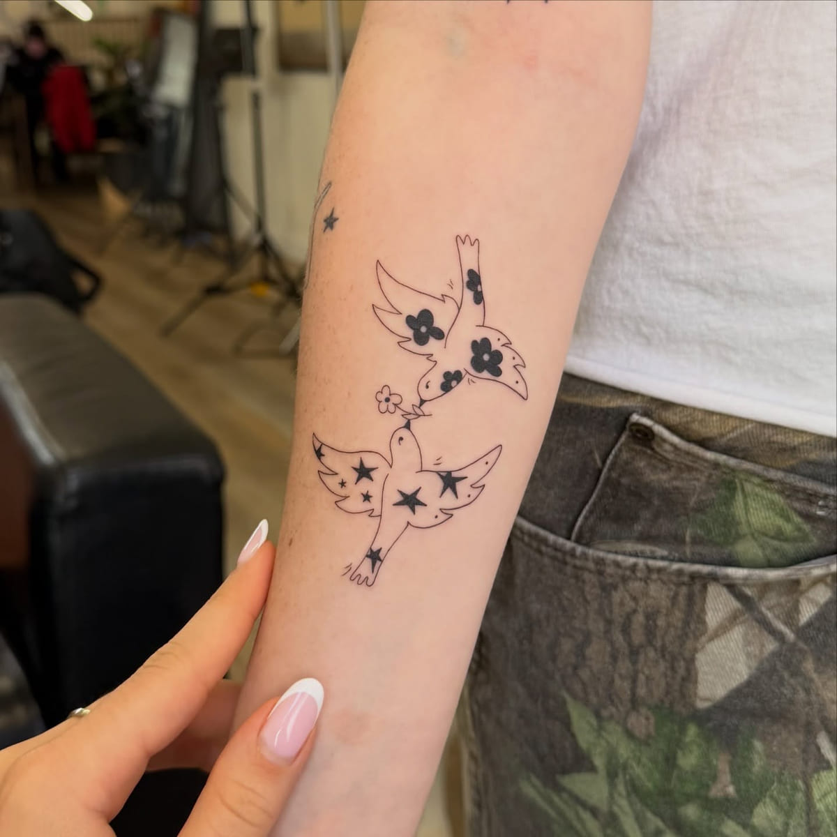 Two birds filled with flowers and stars, another view