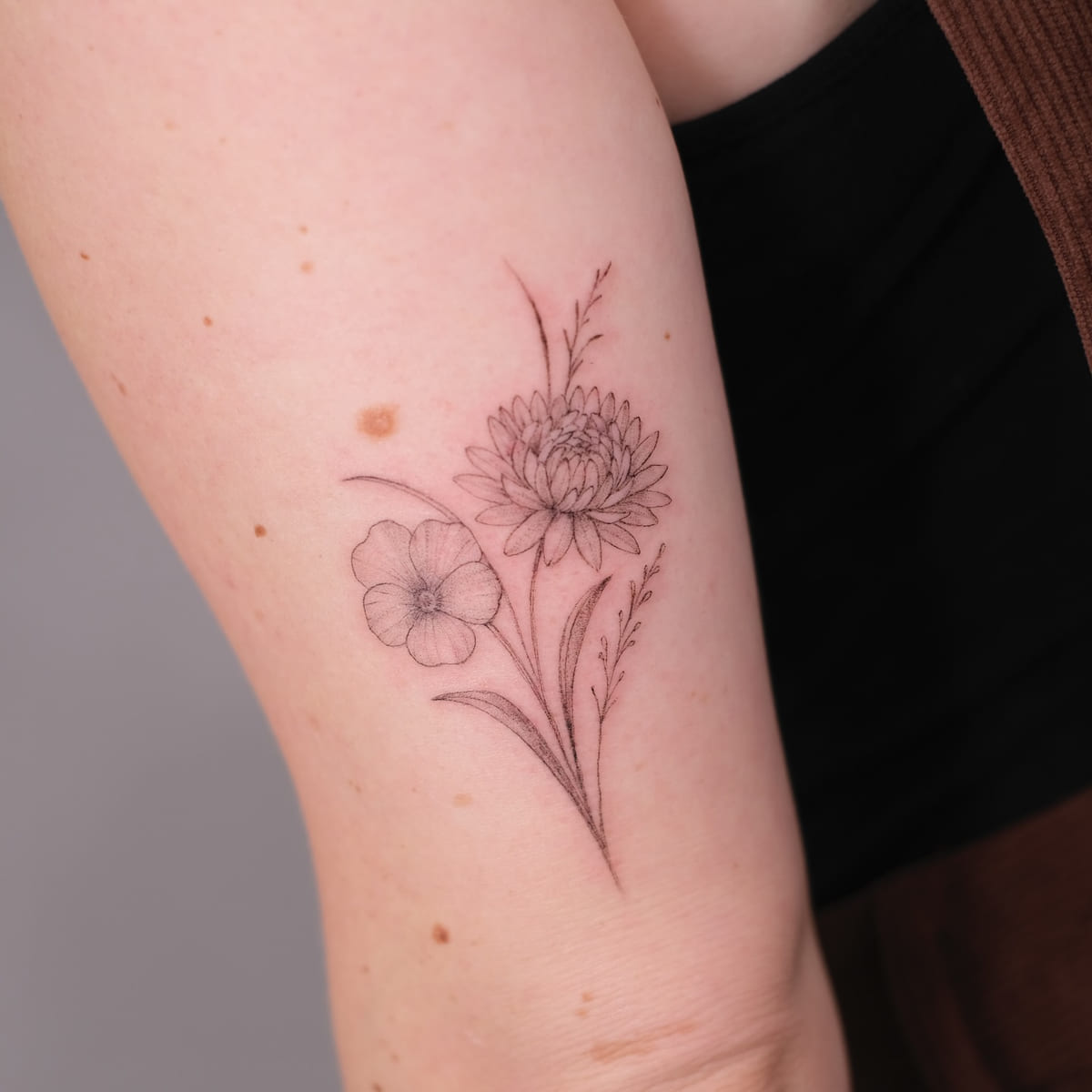 Chrysanthemum and cosmos bouquet, fine line tattoo