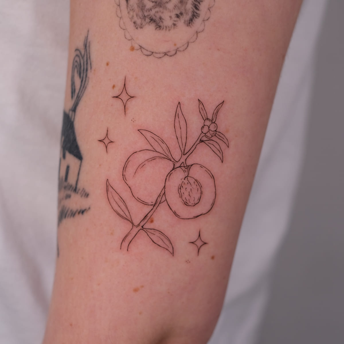 Peach branch with sparkles, fine line tattoo