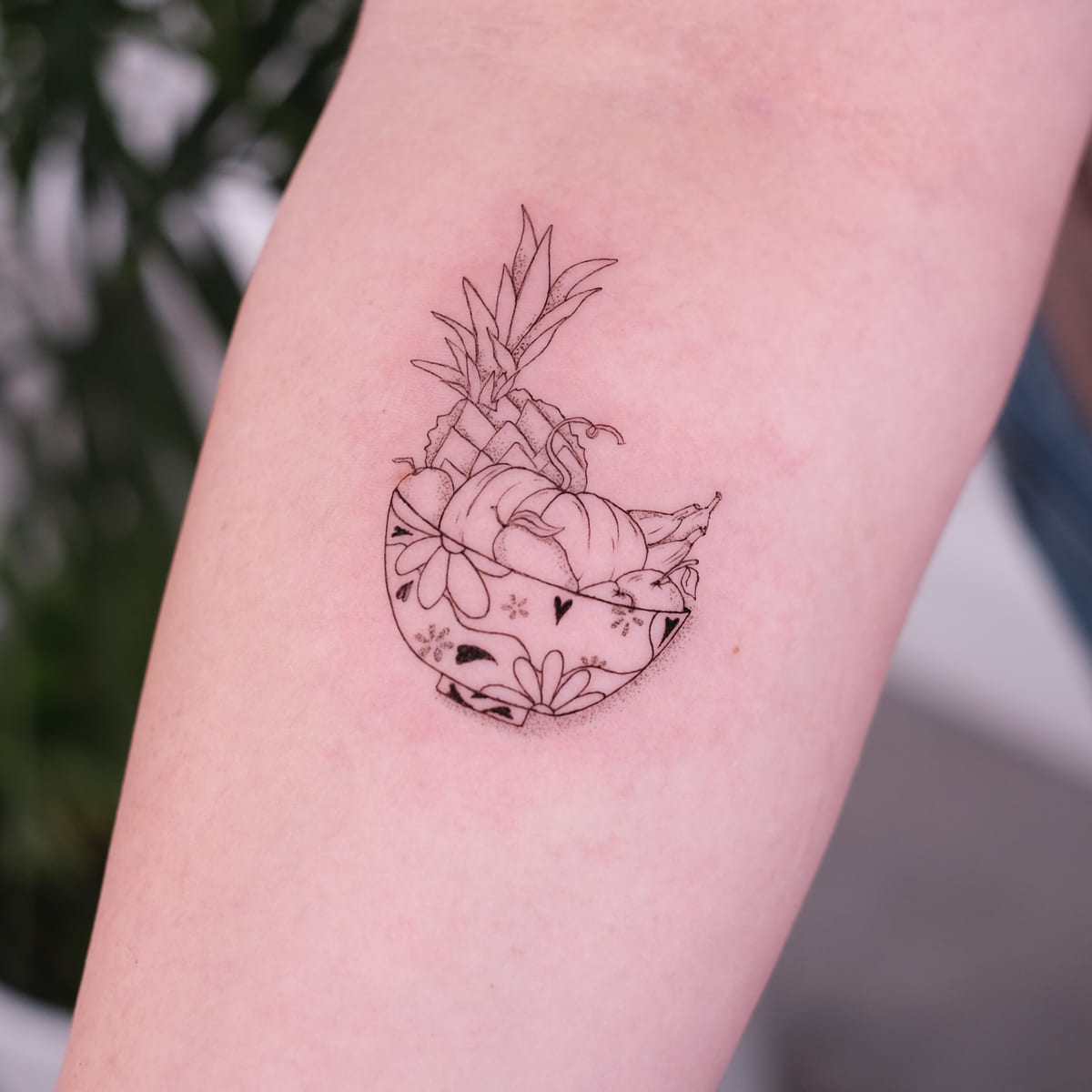 Patterned bowl of fruit with a pineapple, another view