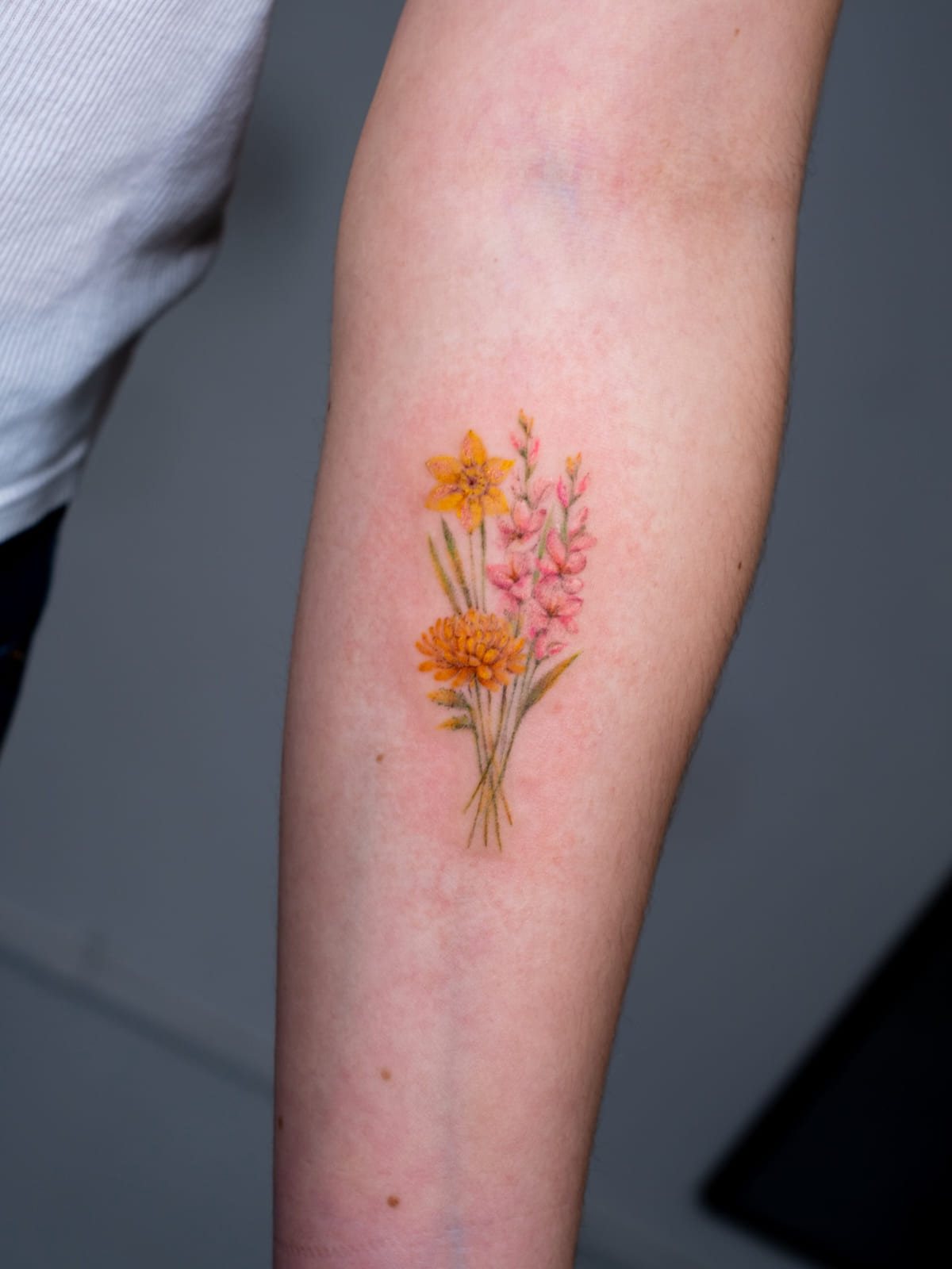 Birth flower bouquet in color: marigold, daffodil, pink larkspur, fine line tattoo