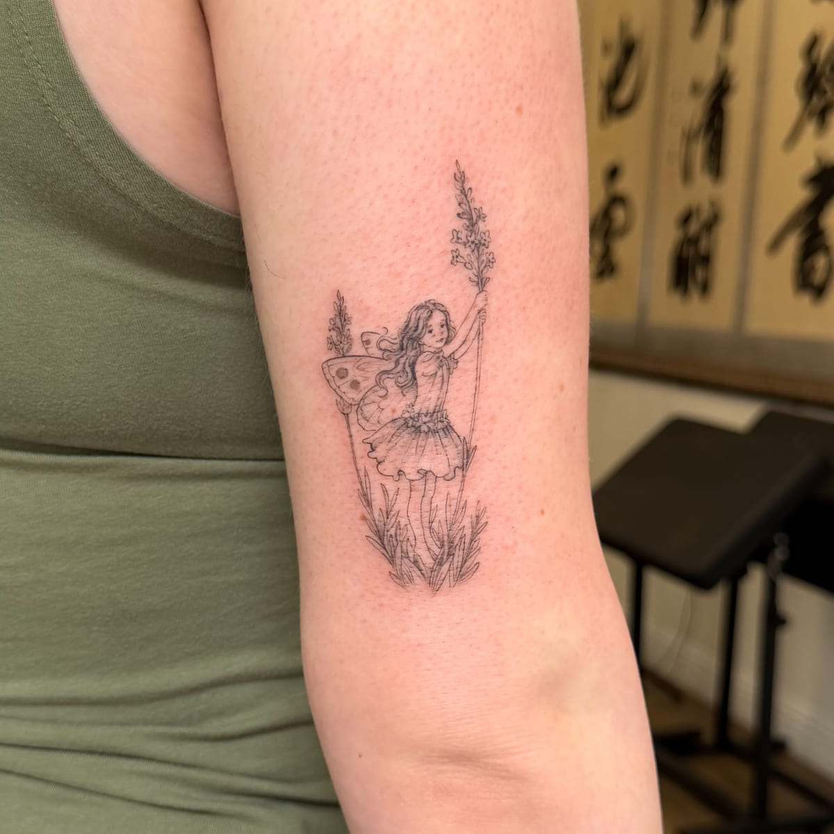 Fairy holding a tall lavender stem, fine line tattoo